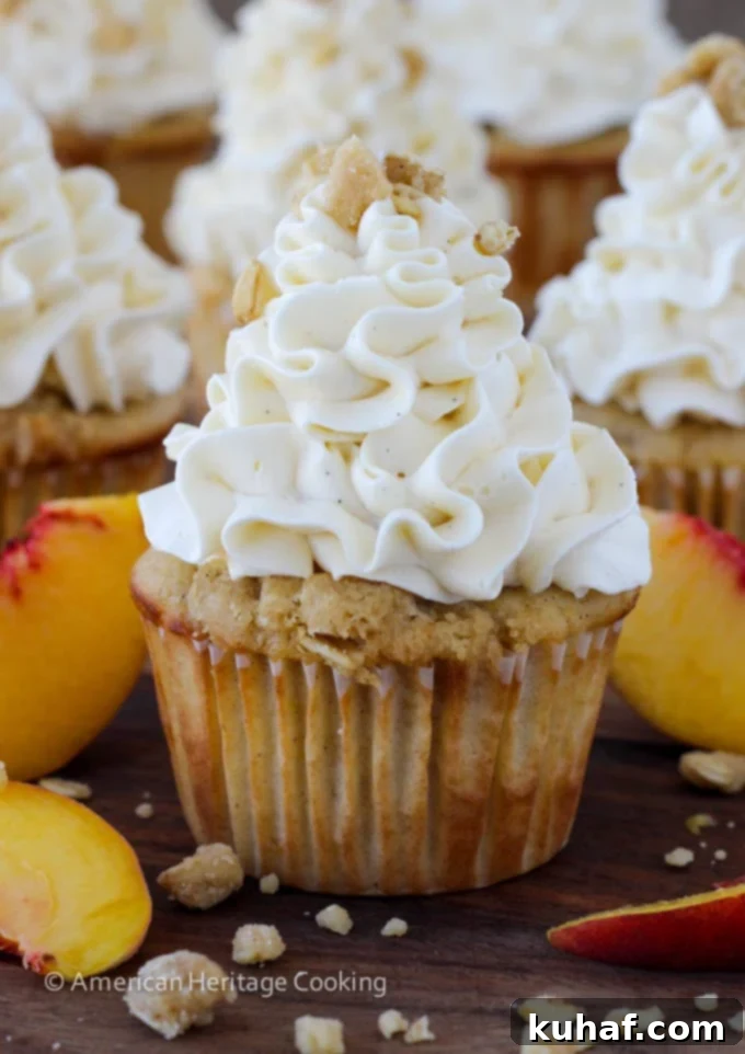 Peach Crisp Cupcakes filled with peach compote and topped with Swiss meringue buttercream