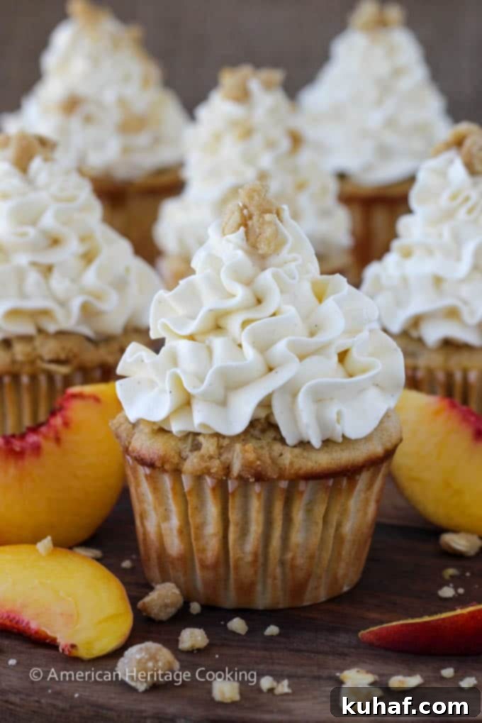 Peach Crisp Cupcakes filled with peach compote and topped with Swiss meringue buttercream