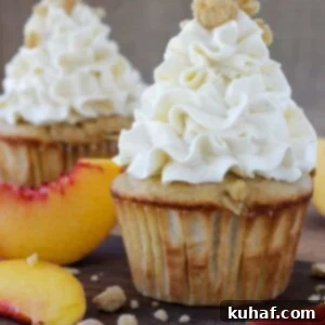 Peach Crisp Cupcakes filled with peach compote and topped with Swiss meringue buttercream