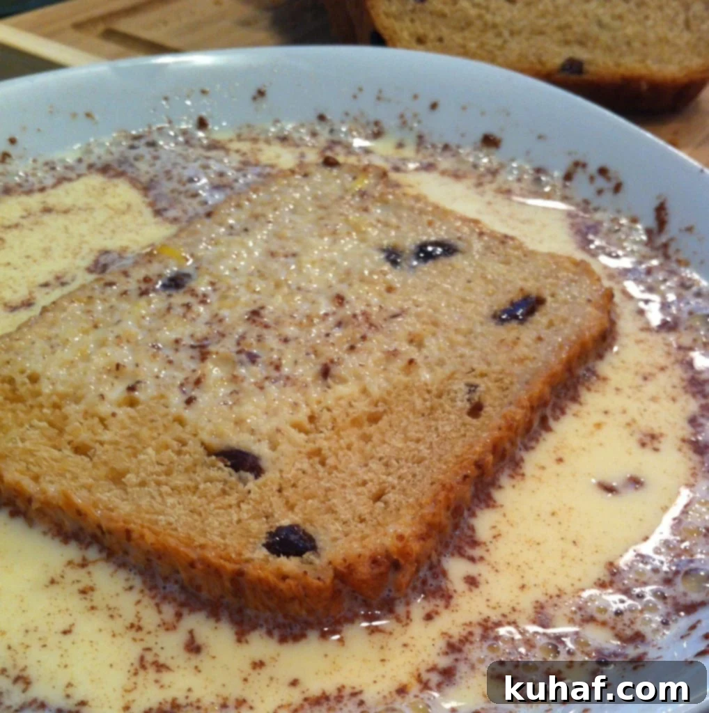 Decadent Cinnamon Raisin French Toast 4 Stacked slices of golden Cinnamon Raisin French Toast drizzled with maple syrup