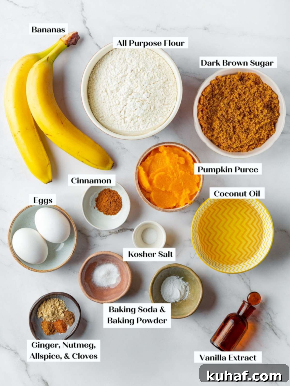 A beautifully arranged countertop displaying all the essential ingredients like flour, pumpkin puree, ripe bananas, and a selection of aromatic spices, perfectly set up for baking pumpkin banana bread.