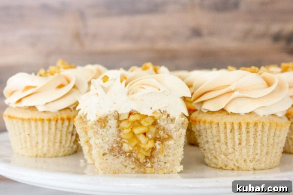 These Caramel Apple Cupcakes are a moist cinnamon cake filled with a spiced apple compote and are frosted with an easy salted caramel buttercream!