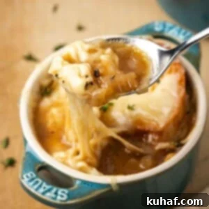 perfect bite of french onion soup on spoon.