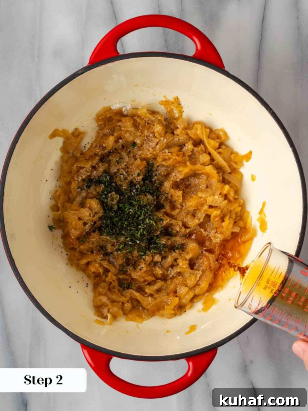 adding thyme and cognac to caramelized onions in pot.