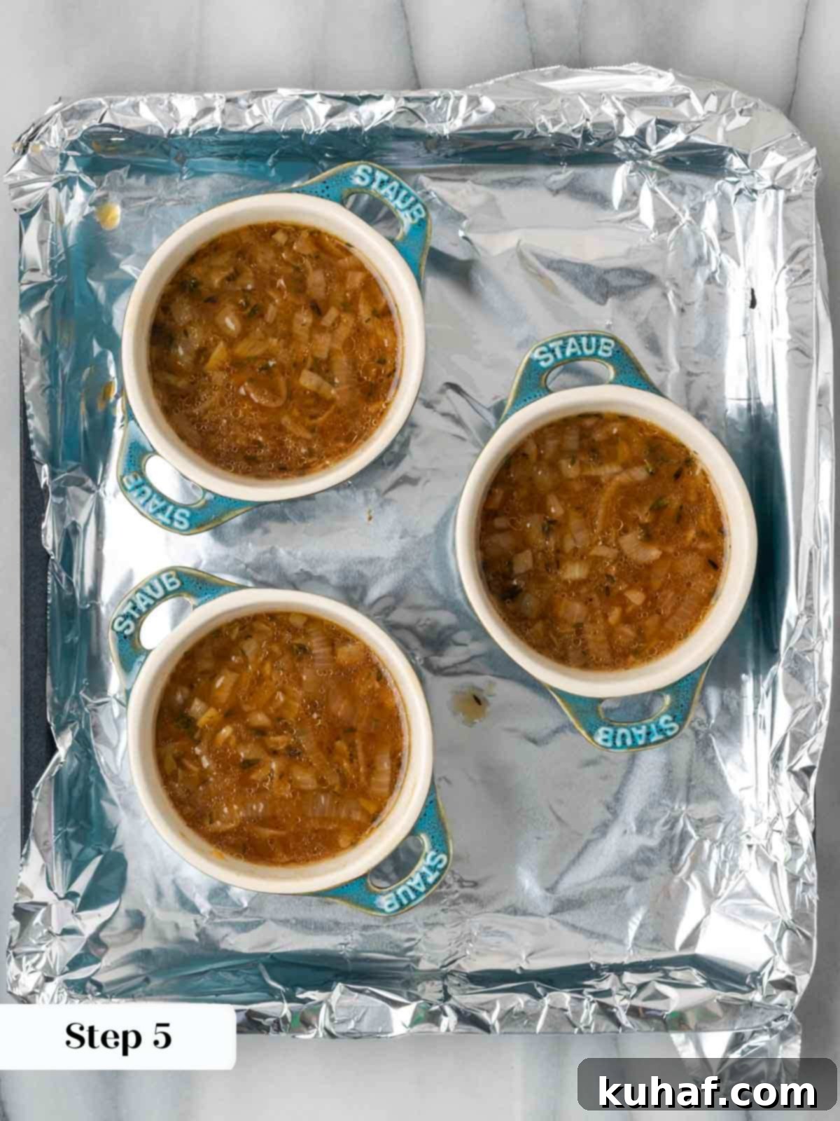 portioning onion soup into ramekins.