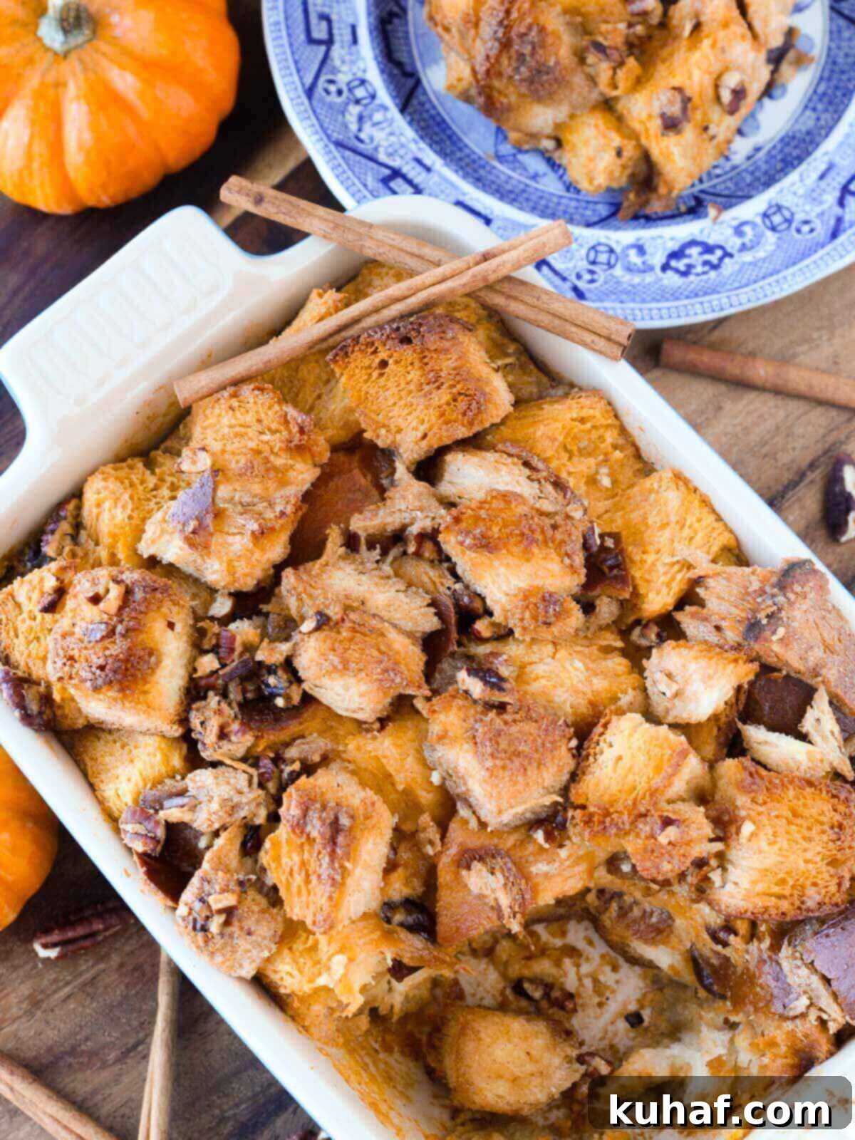 Pumpkin bread pudding in a blue baking dish, ready to be served.