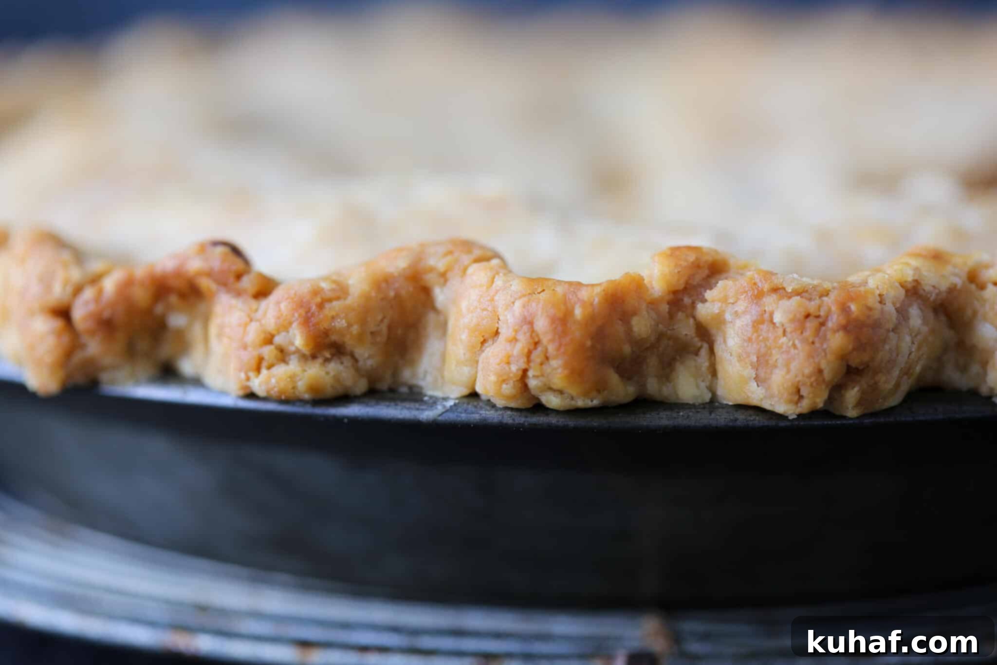 Detail shot of a perfectly baked pie crust, golden brown and crisp.