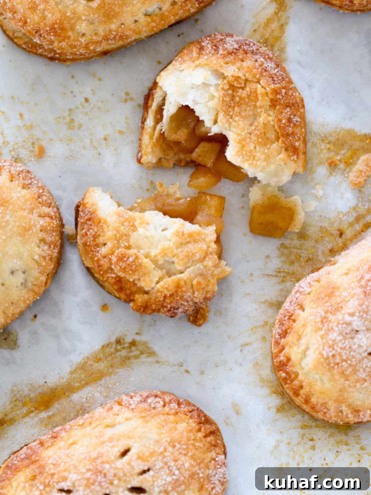 Delicious apple hand pie, broken open to reveal perfectly cooked spiced apple filling inside.