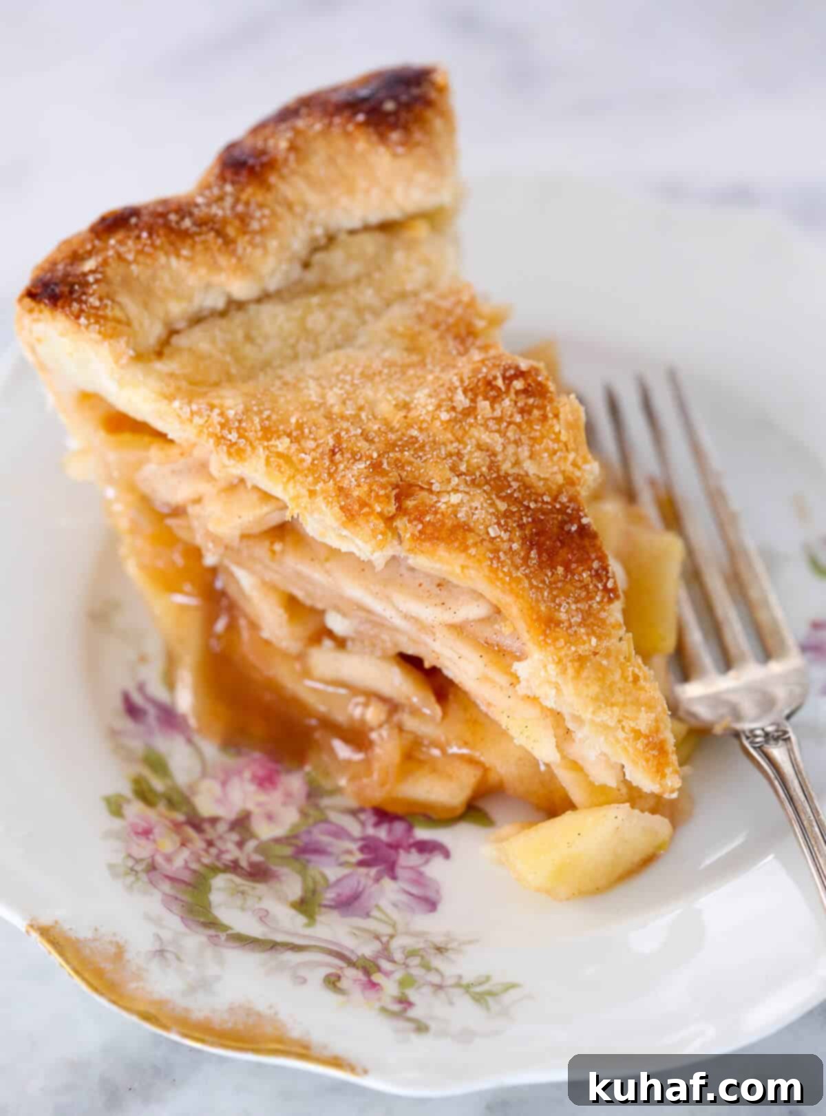 A small bowl filled with aromatic apple pie spice mix on a pretty floral plate.