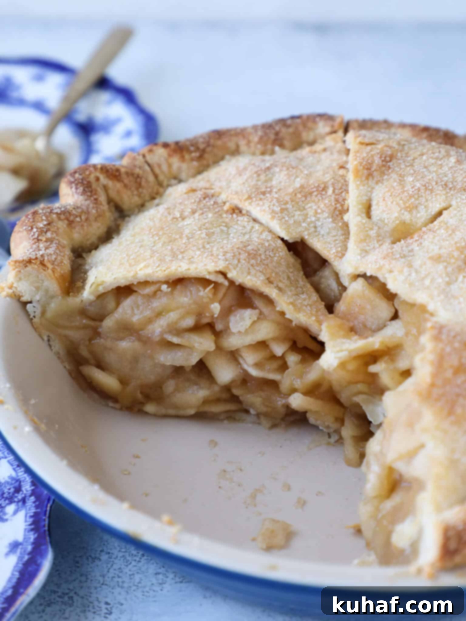 A glorious slice of Mile High Apple Pie, showing its impressive layers of apple filling and golden crust.