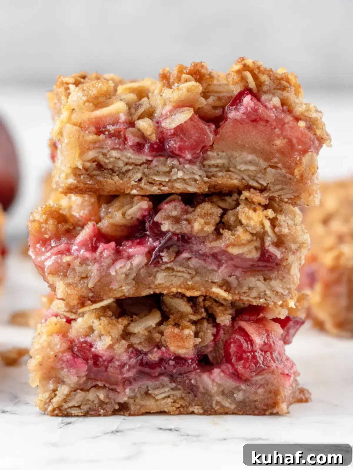Stack of delicious apple plum crumble bars, showing their crumbly topping and fruity layers.