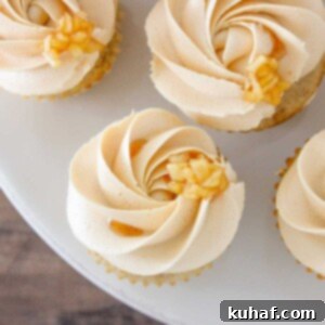Caramel Apple Cupcakes displayed elegantly on a marble cake stand, showcasing their beautiful frosting and apple aroma.
