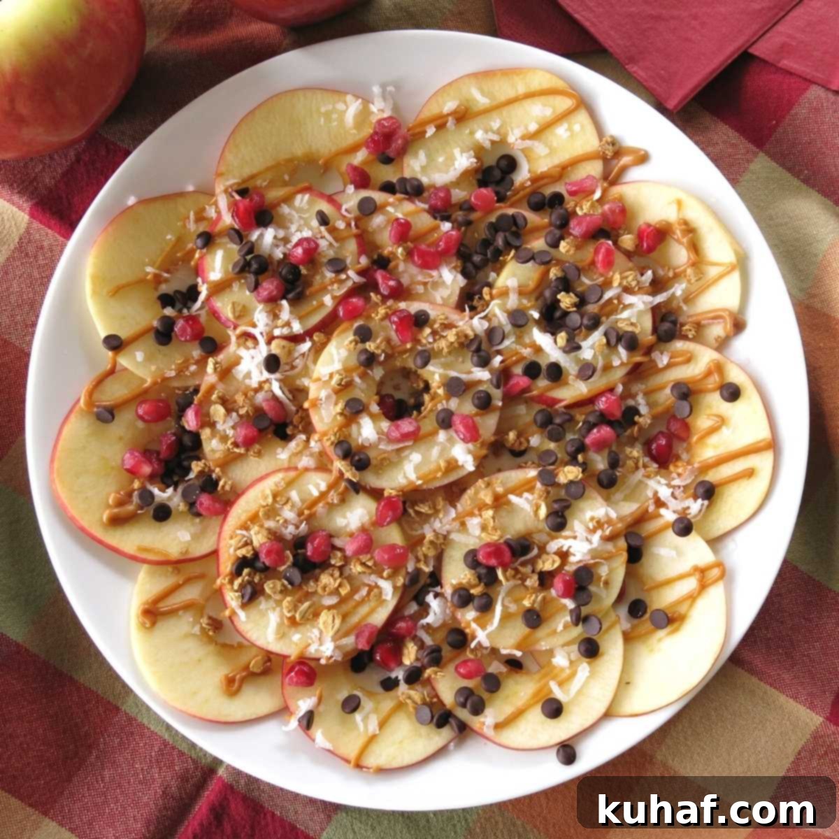 A vibrant platter of apple dessert nachos, generously topped with caramel sauce and various sweet toppings.