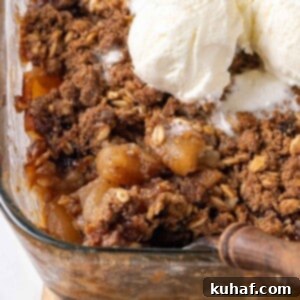 baked apple crisp being dished.