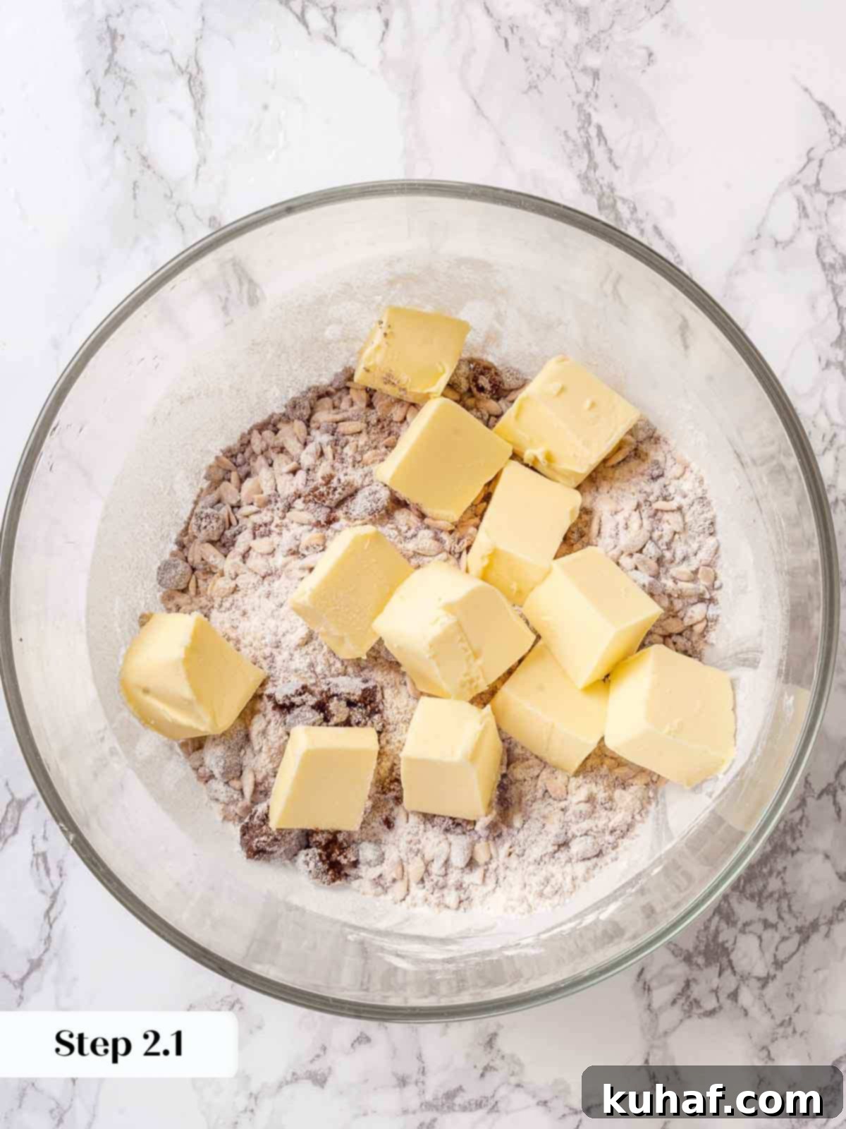 Dry ingredients for apple crisp topping (sugar, flour, oats) in a bowl before butter is added.