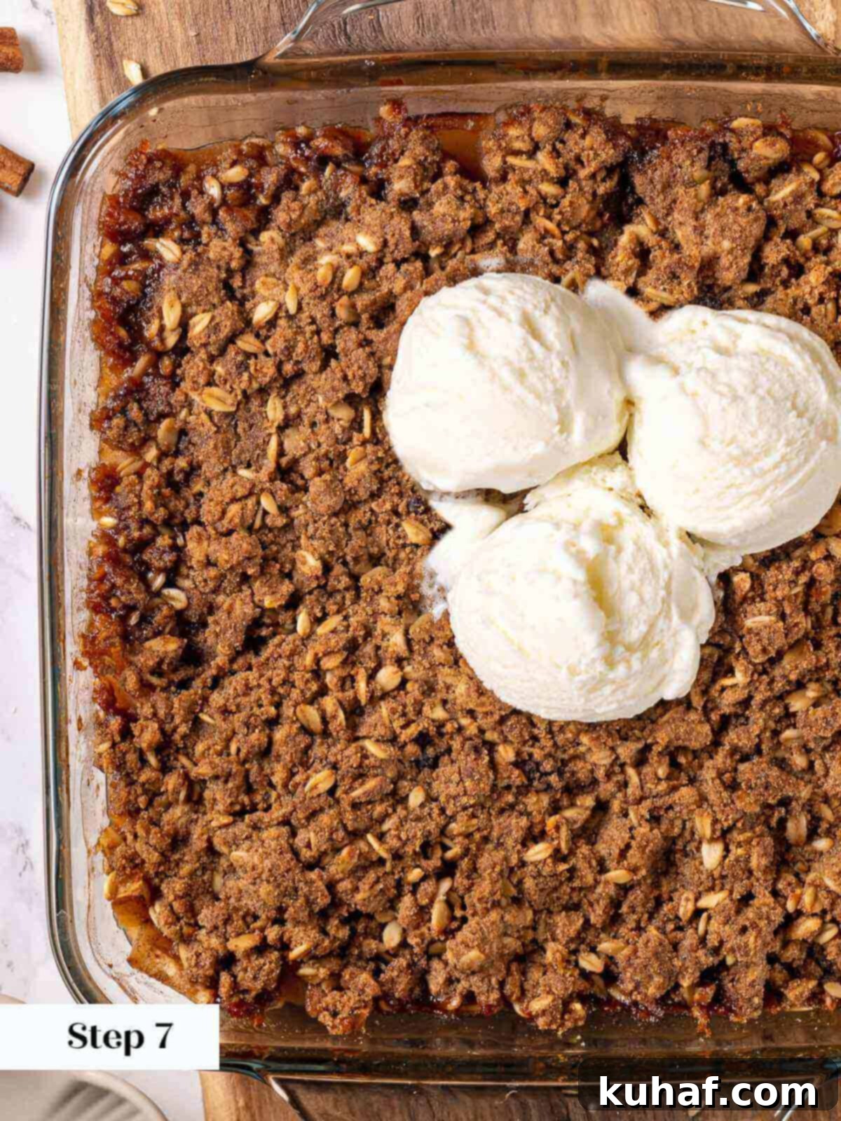 Freshly baked apple crisp in a square baking dish, with a golden-brown, bubbly topping.