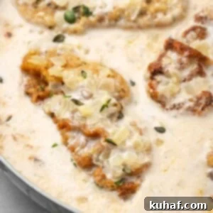 pork chop in sauce in pan with thyme.