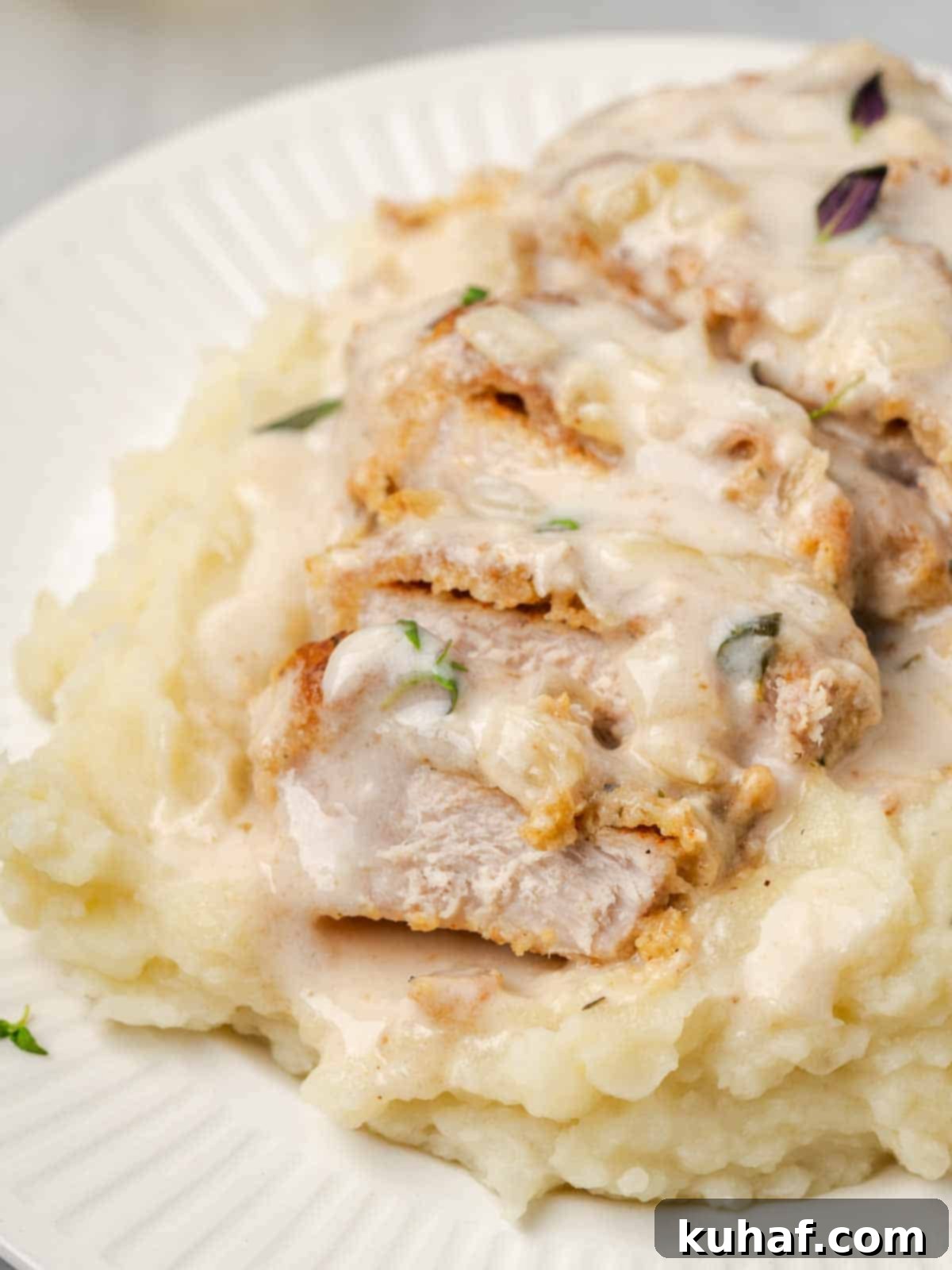 sliced pork chop on mashed potatoes.