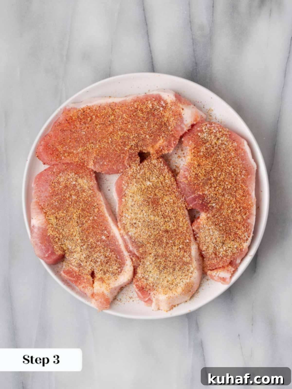 seasoned pork chops on plate.