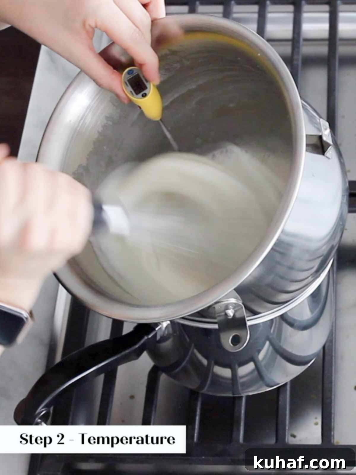 checking temperature of whipping swiss meringue.