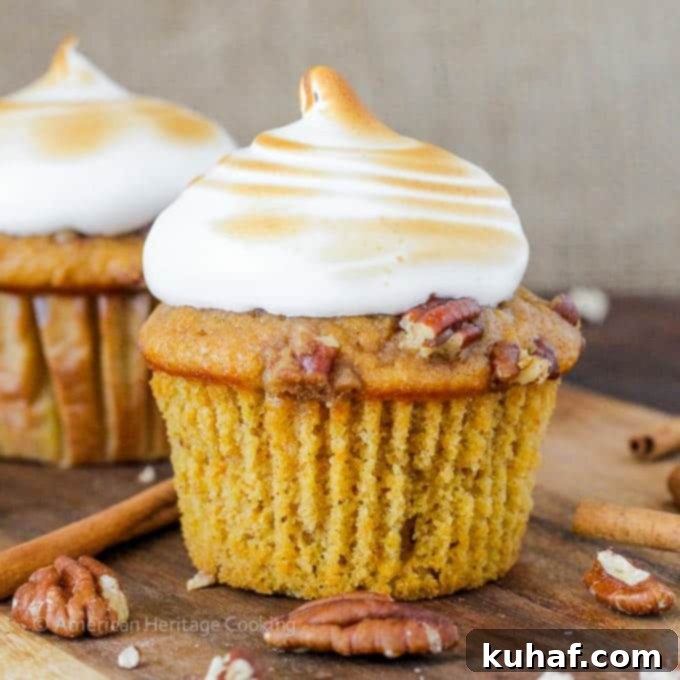 Sweet Potato Casserole Cupcakes with Homemade Marshmallow Frosting, showcasing the toasted marshmallow topping and pecan streusel. A perfect holiday dessert.