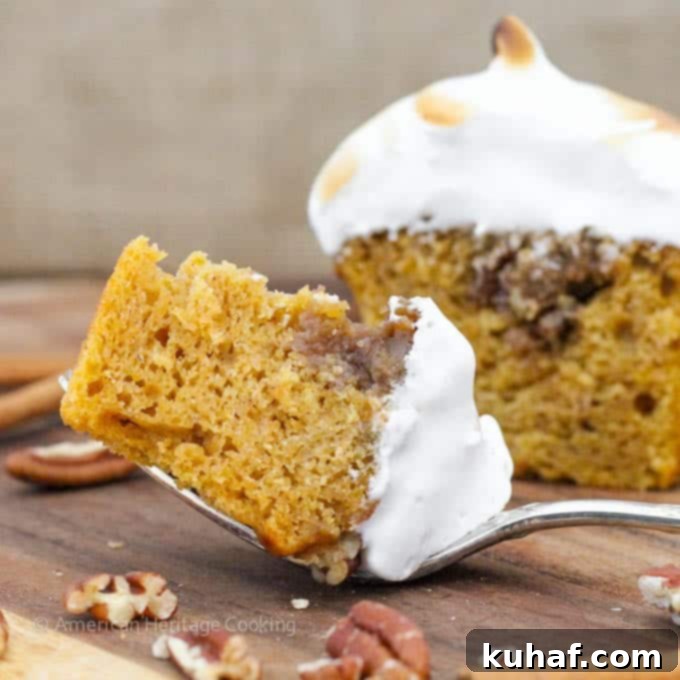 Close-up of a Sweet Potato Casserole Cupcake, highlighting the fluffy homemade marshmallow frosting and warm colors.