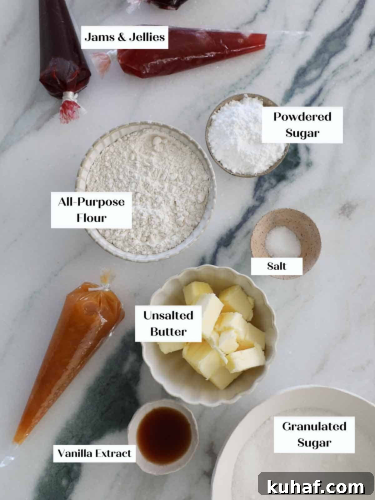 A flat lay image of vanilla thumbprint cookie ingredients: butter, powdered sugar, flour, salt, and vanilla extract.
