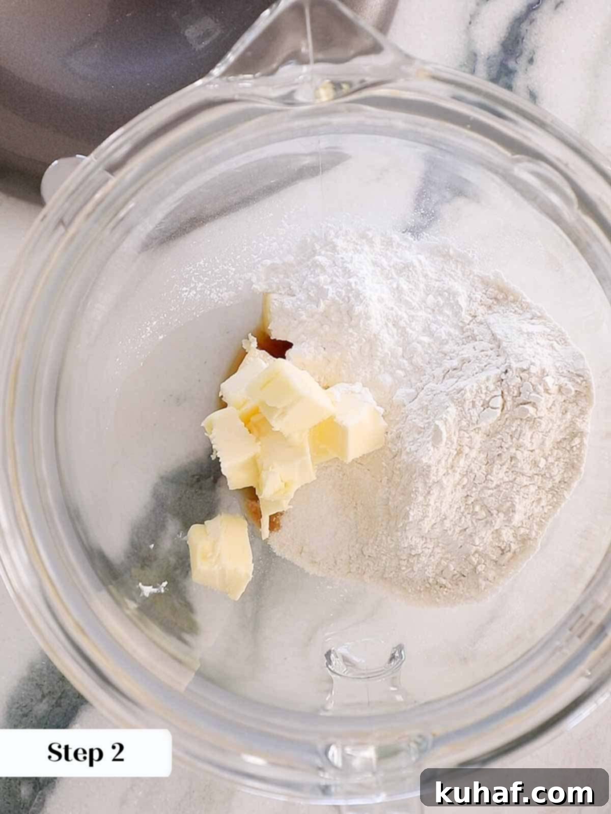 Dry ingredients and butter in a stand mixer bowl, ready to be mixed.