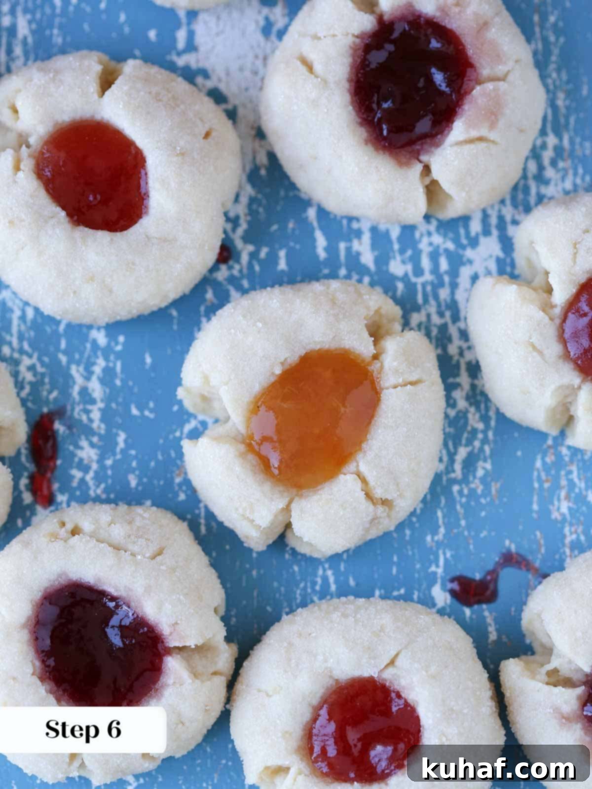 Freshly baked thumbprint cookies cooling on a wire rack.