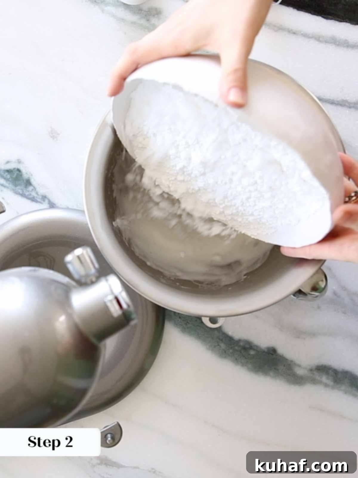 adding powdered sugar to meringue.
