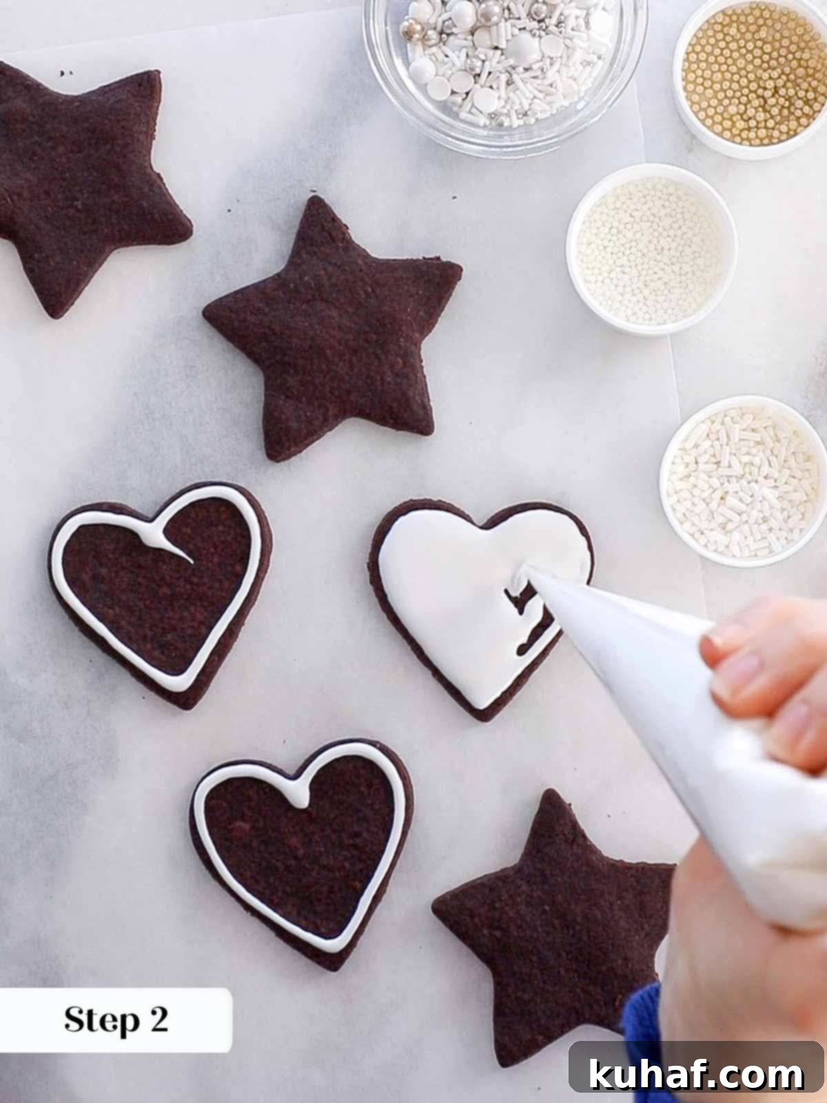 flooding a chocolate sugar cookie with smooth easy cookie icing.