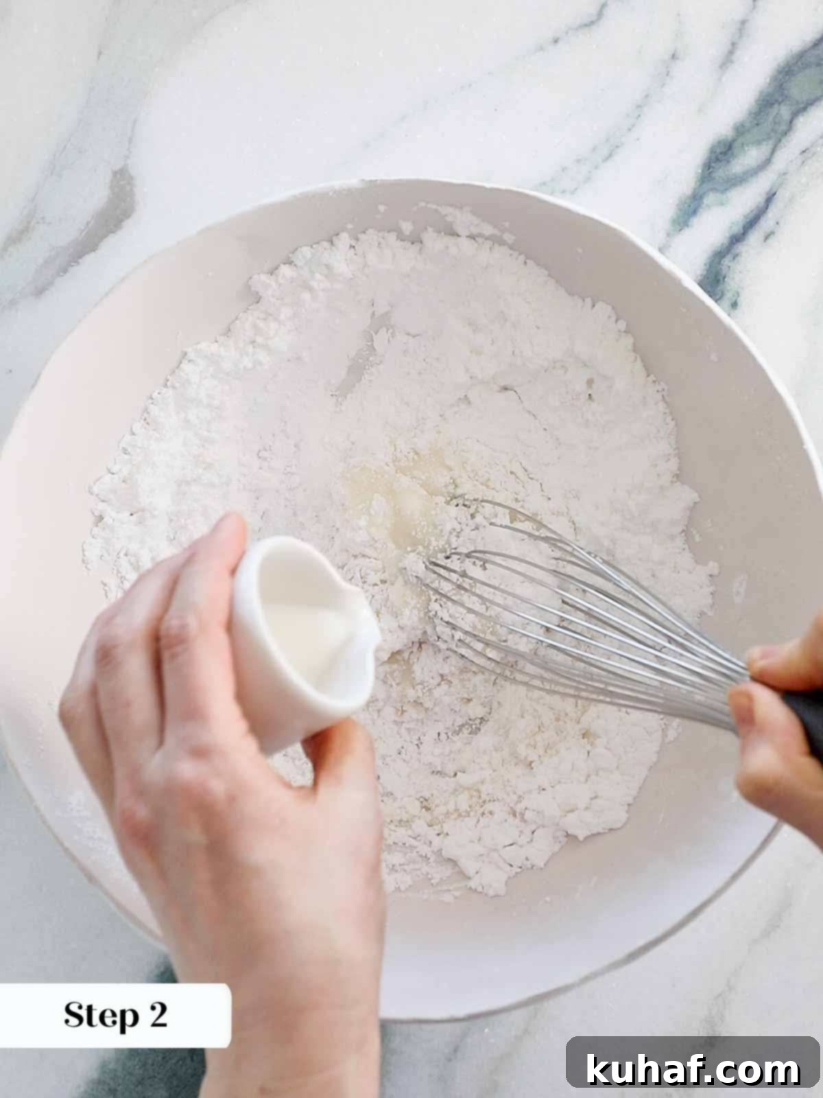 whisking all ingredients together to create smooth easy cookie icing.