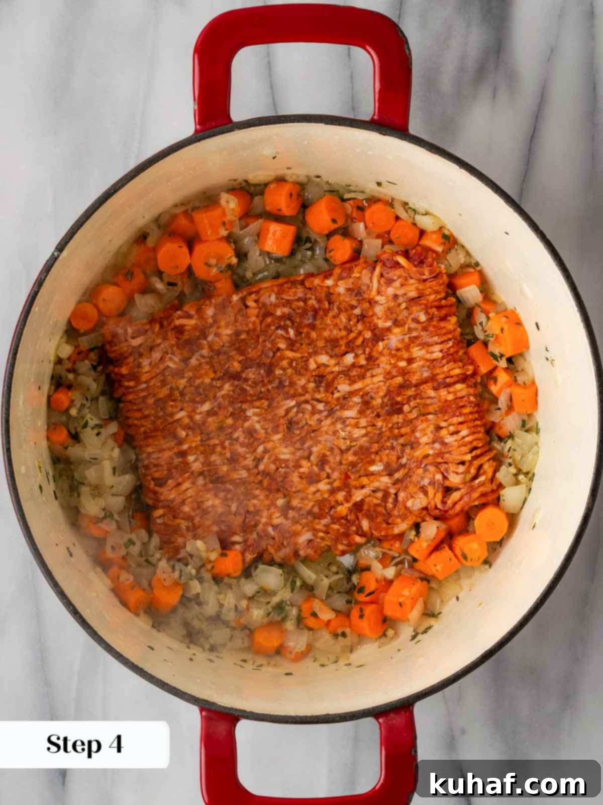 Browning hot Italian sausage with vegetables.