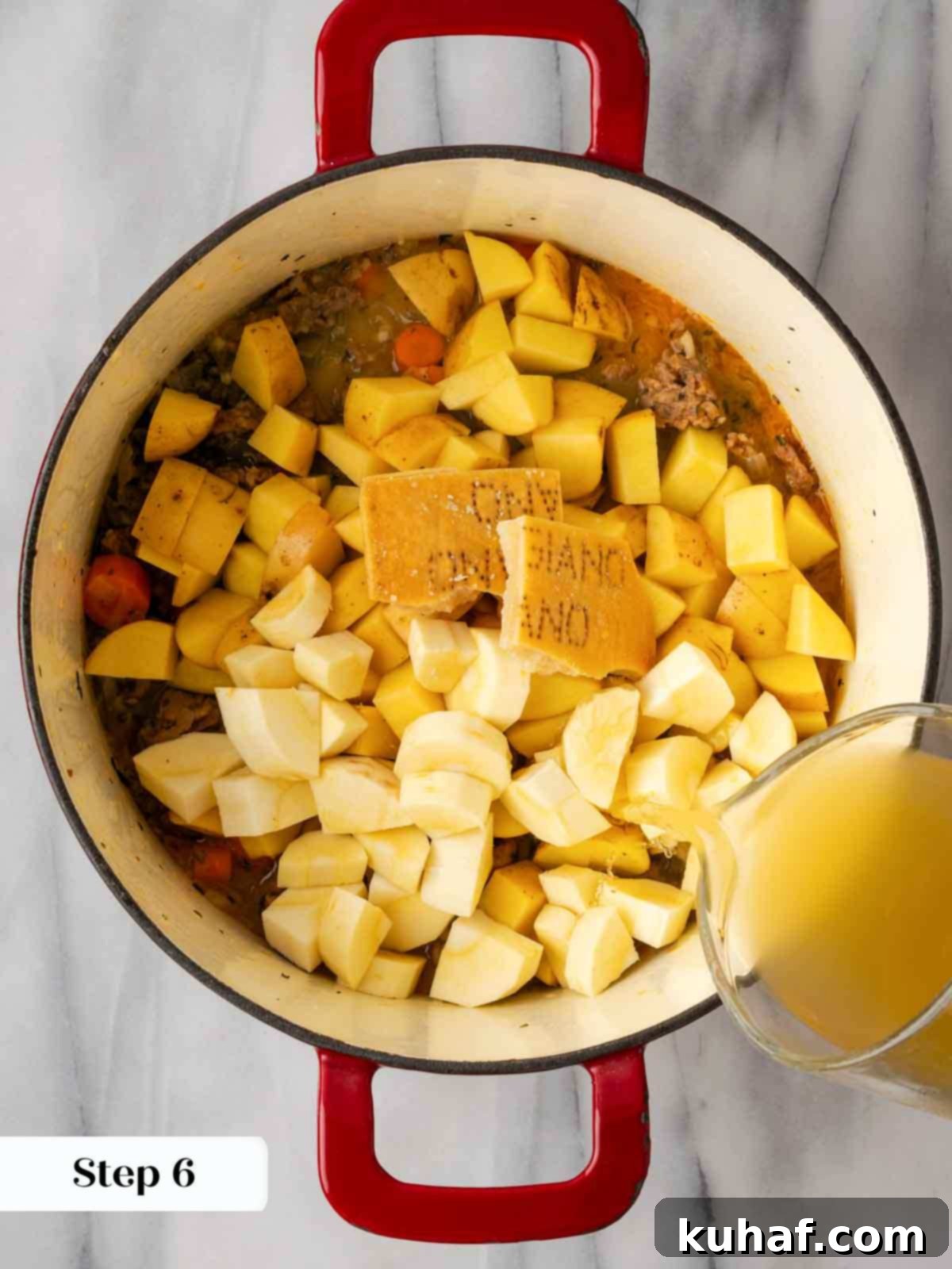 adding chicken stock to pot.