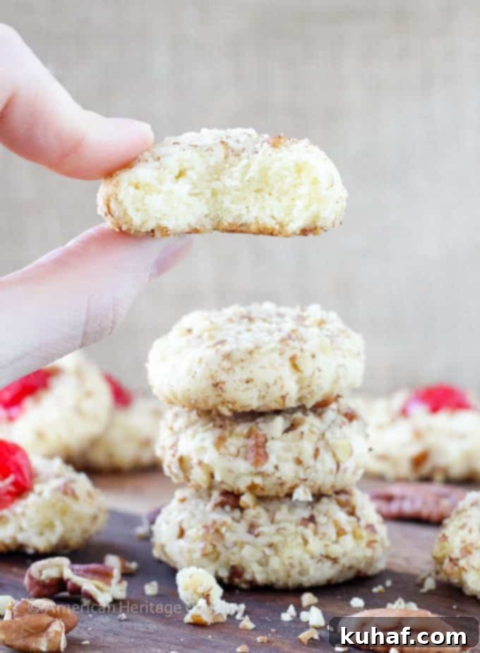 These easy Cherry Pecan Cookies are soft, chewy and nutty. A cream cheese sugar cookie is generously flavored with almond extract and rolled in pecans! My favorite Christmas Cookie recipe of all time! 