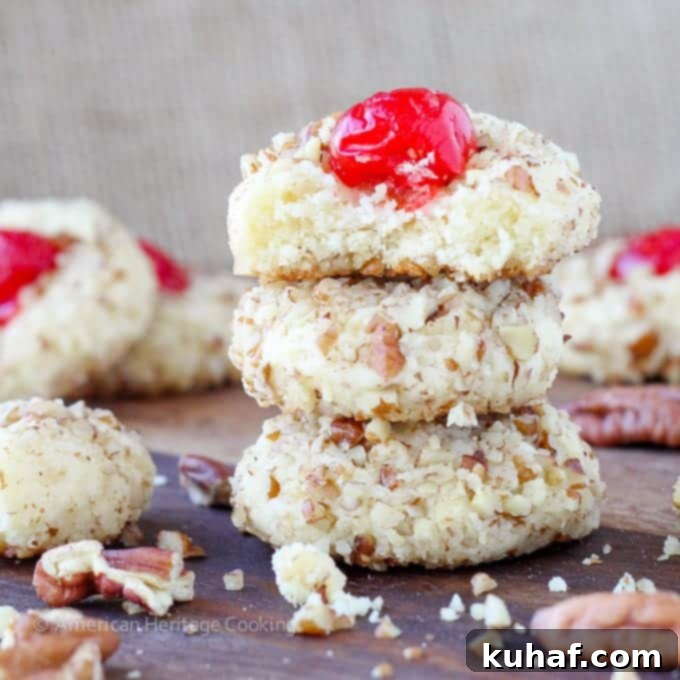 These easy Cherry Pecan Cookies are soft, chewy and nutty. A cream cheese sugar cookie is generously flavored with almond extract and rolled in pecans! My favorite Christmas Cookie recipe of all time! 