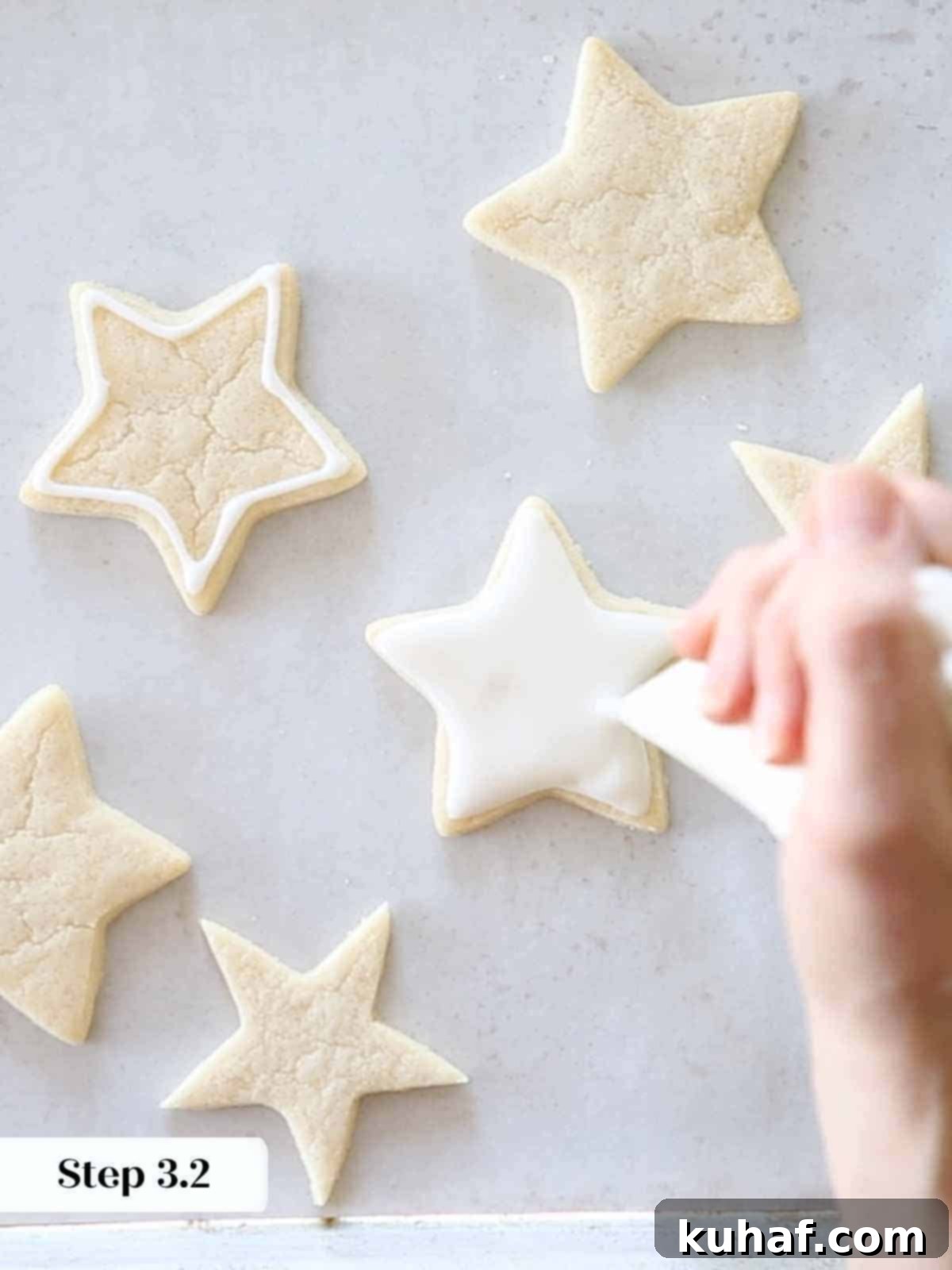 flooding white royal icing on sugar cookie stars.