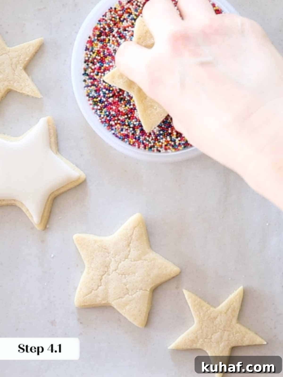 dipping iced cookies in rainbow jimmies.