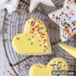 icing yellow heart shaped sugar cookies.