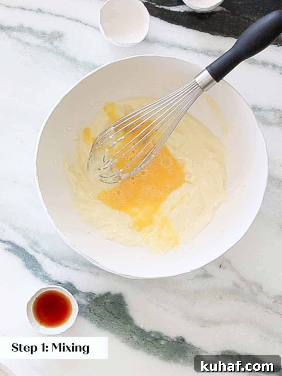 whisking eggs into batter.