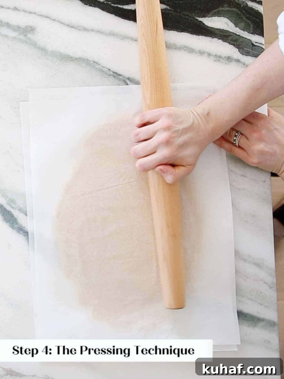 pressing dough with rolling pin to smooth and flatten. 
