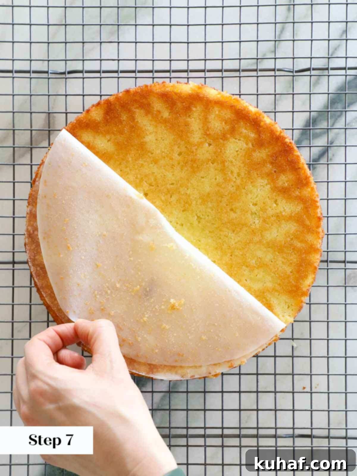 pealing parchment circle from bottom of cooling cake.
