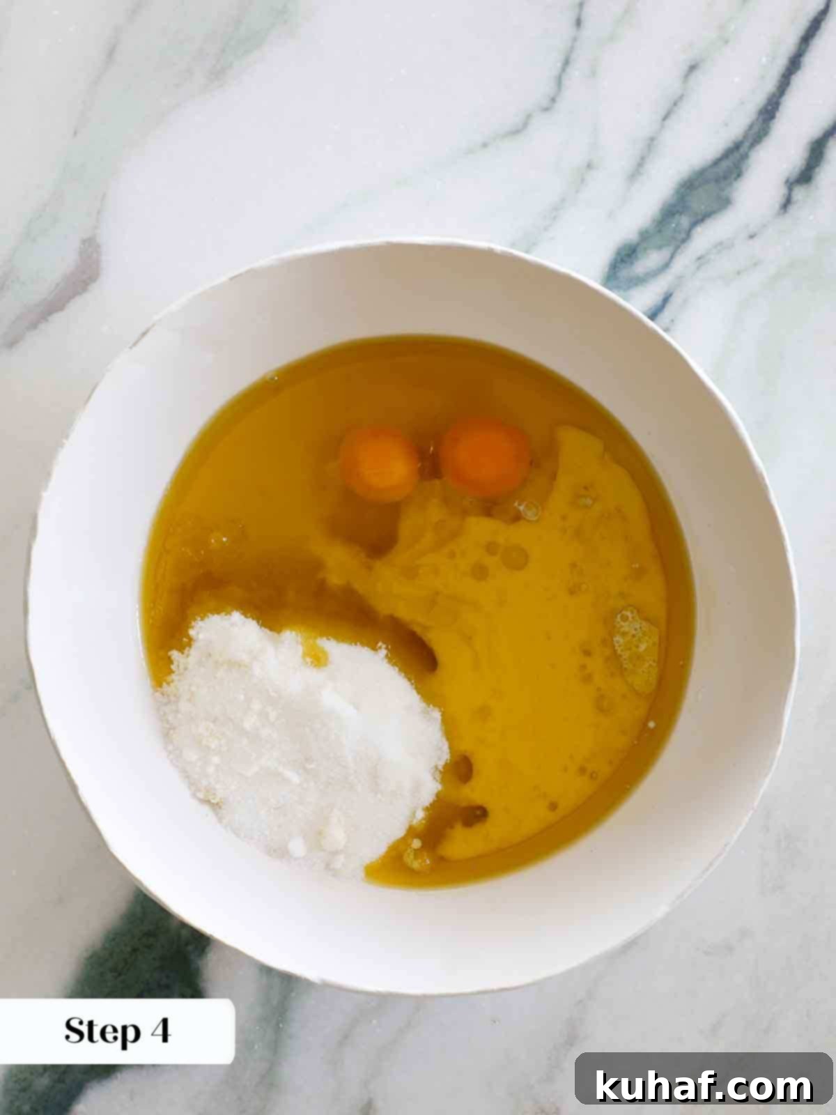 wet ingredients for olive oil cake in white mixing bowl.