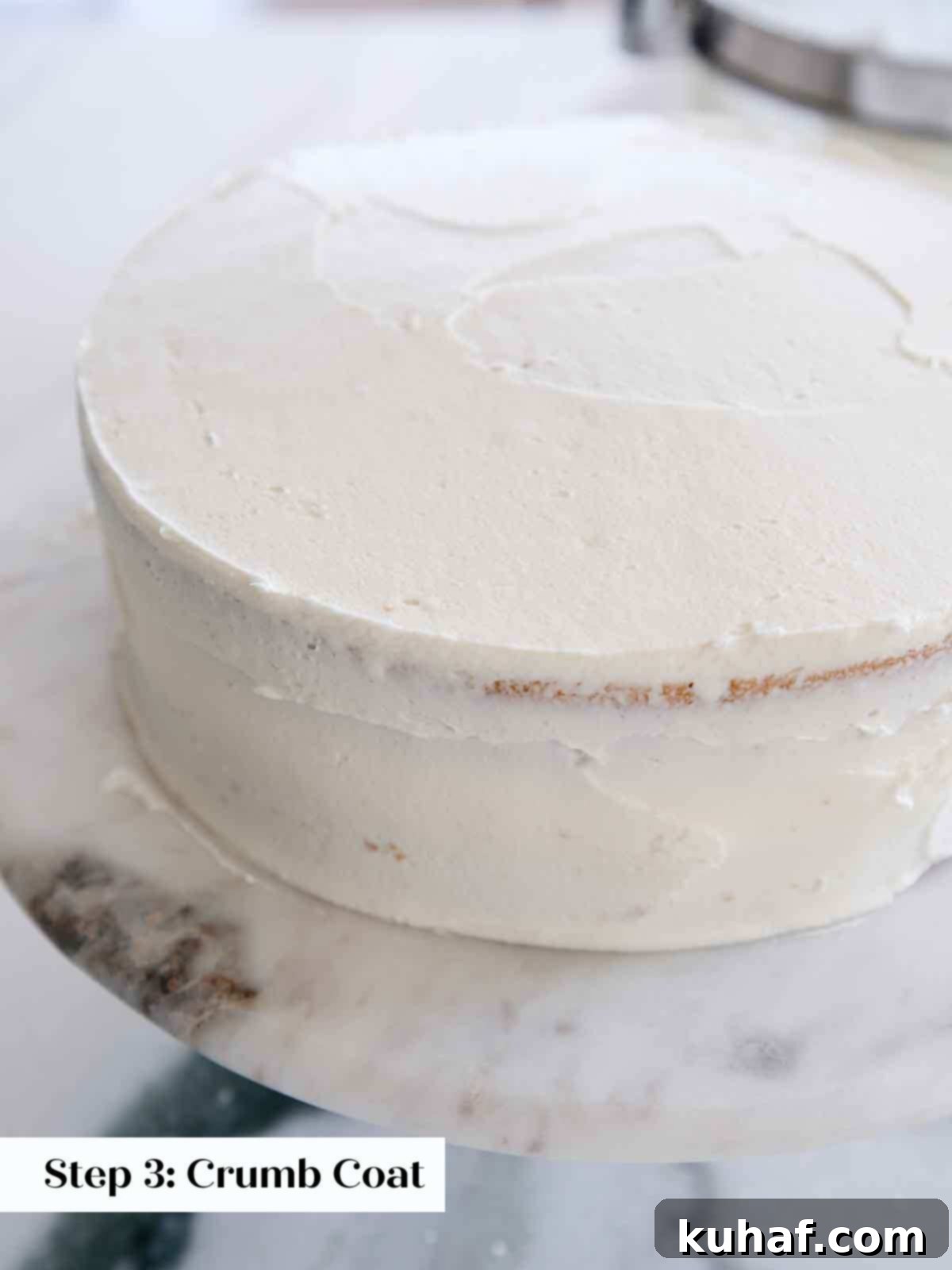 Vanilla cake with a neatly applied crumb coat.