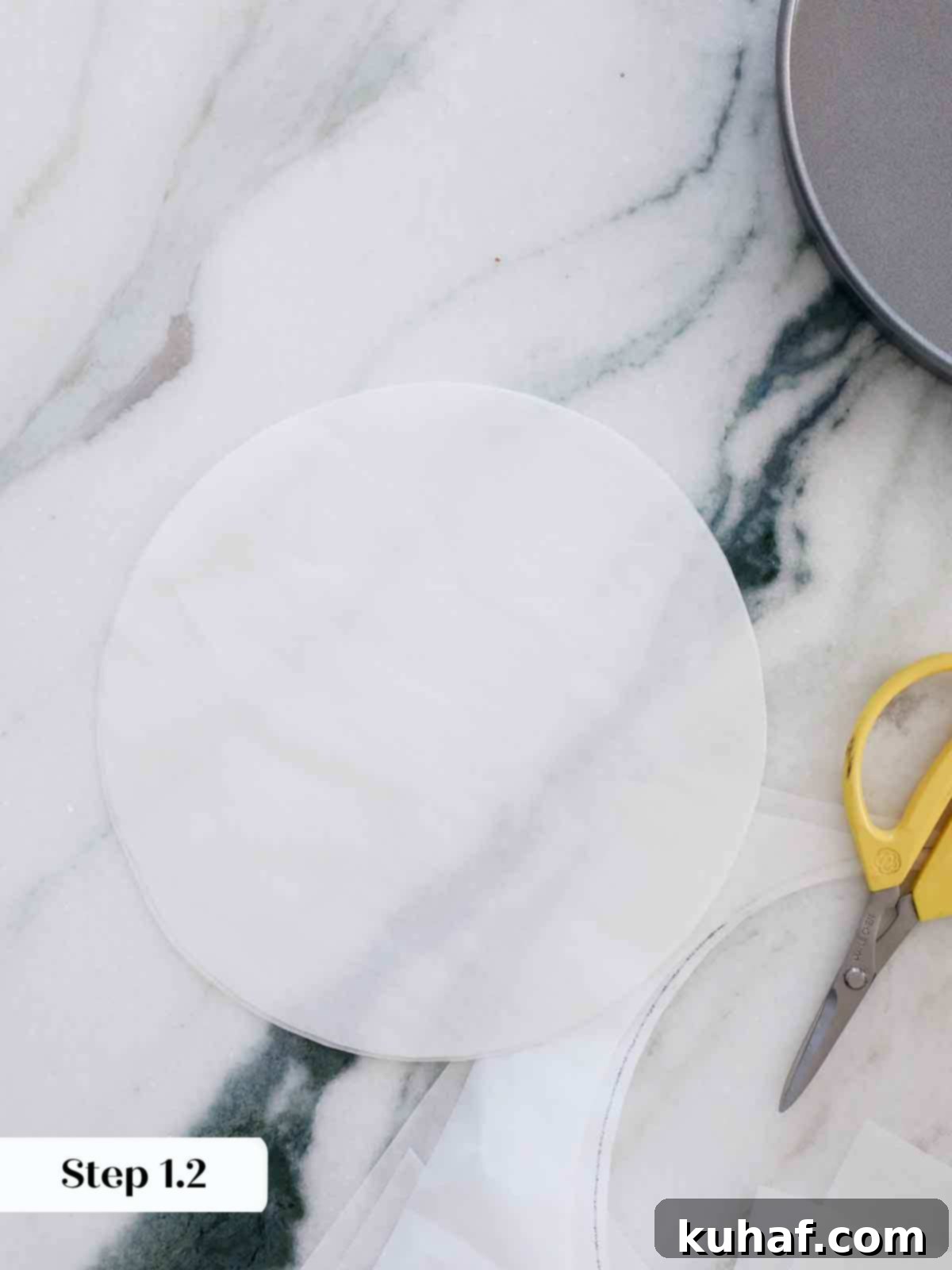 Cutting out parchment paper circles to line cake pans.