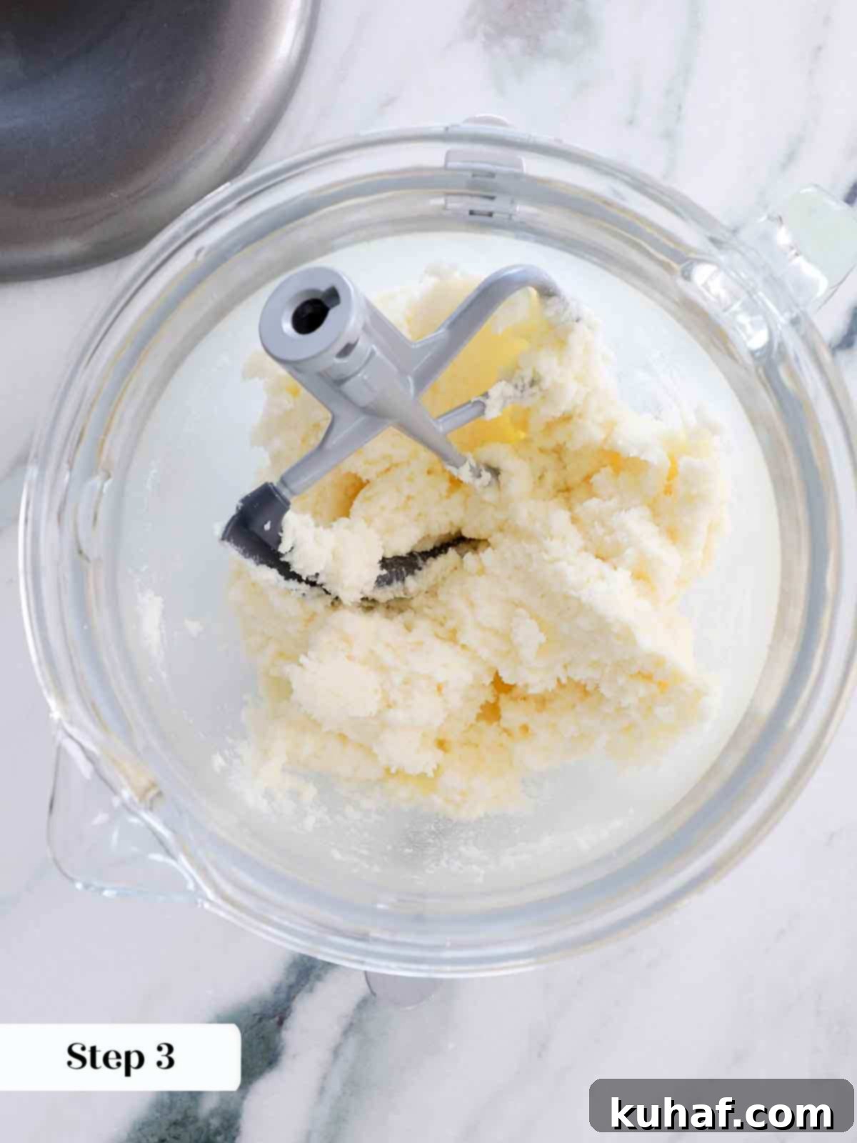Close-up of perfectly creamed butter and sugar in a stand mixer for vanilla cake batter.