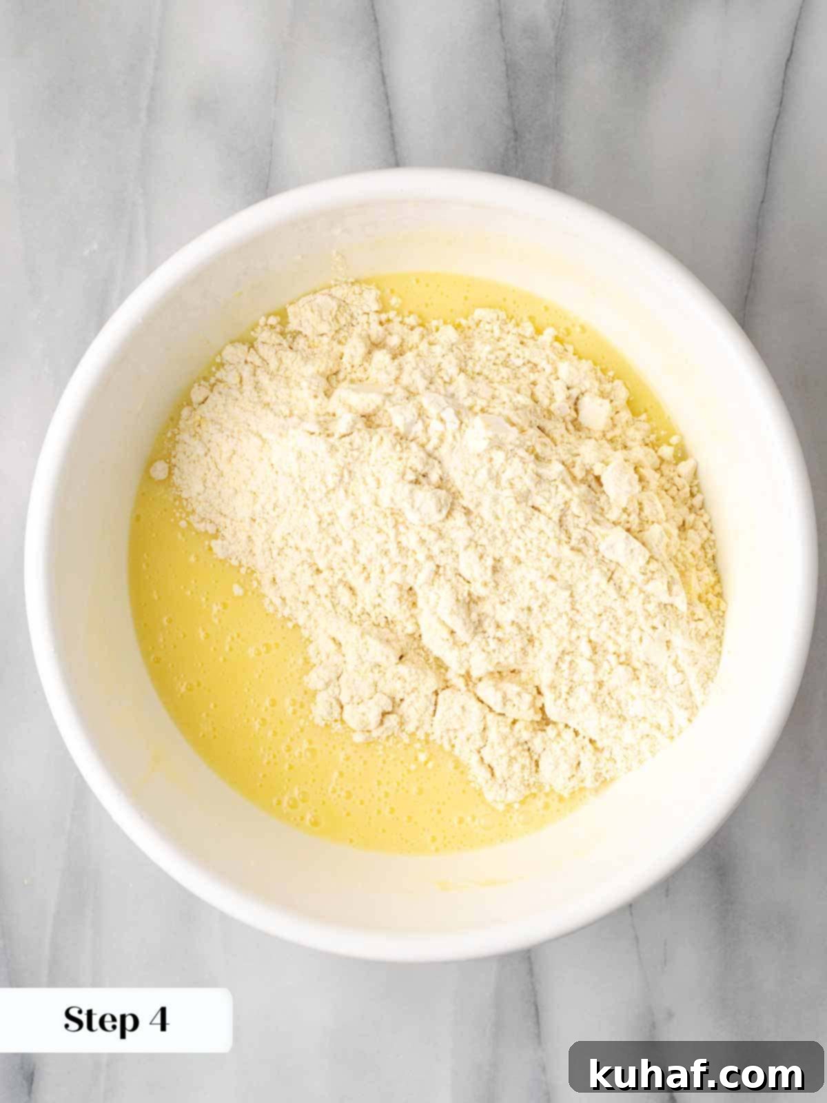 adding dry ingredients to cornbread batter.
