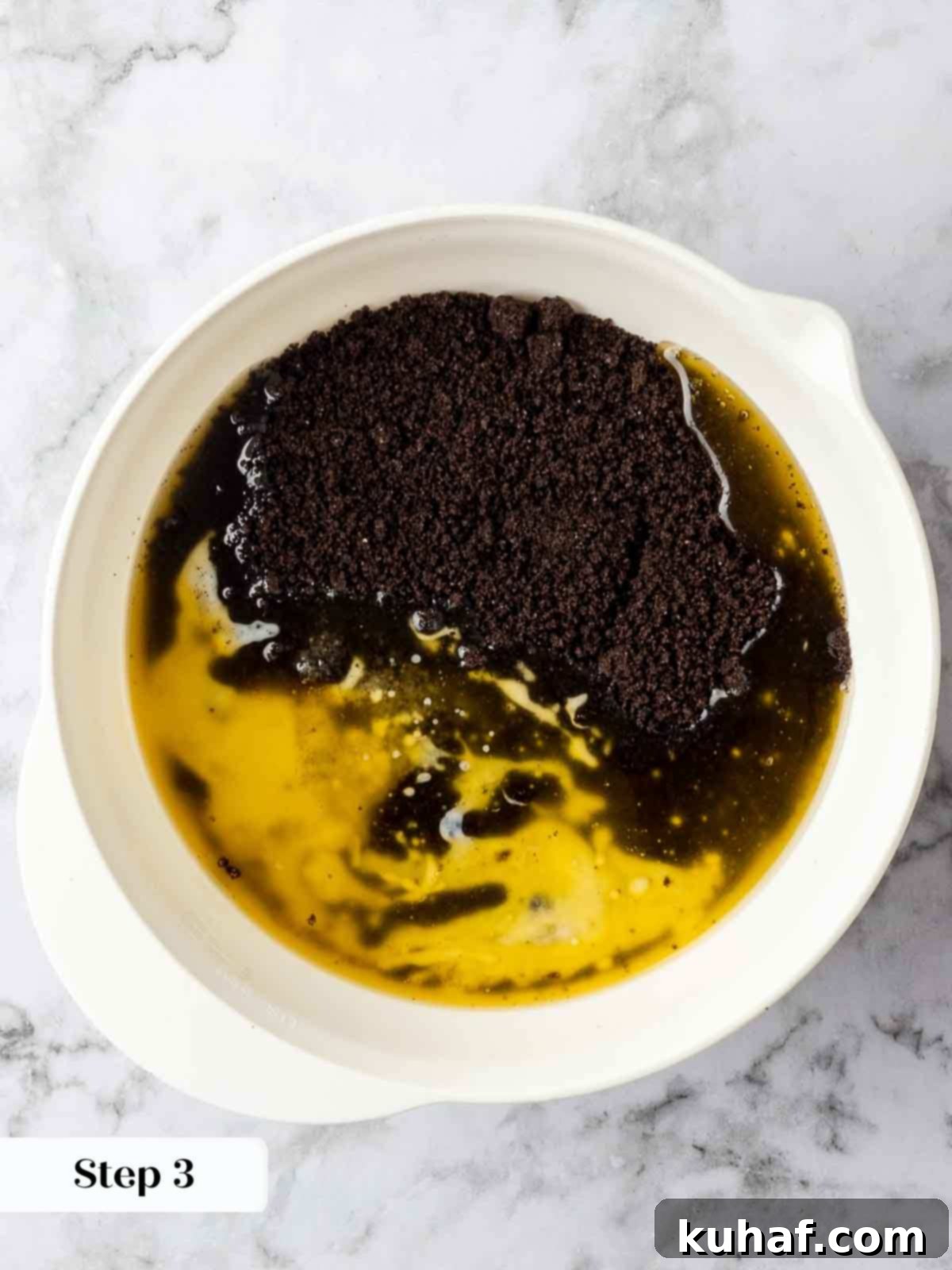 mixing oreo crust in white bowl.