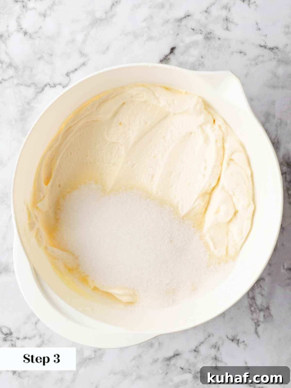 beating sugar into cream cheese.