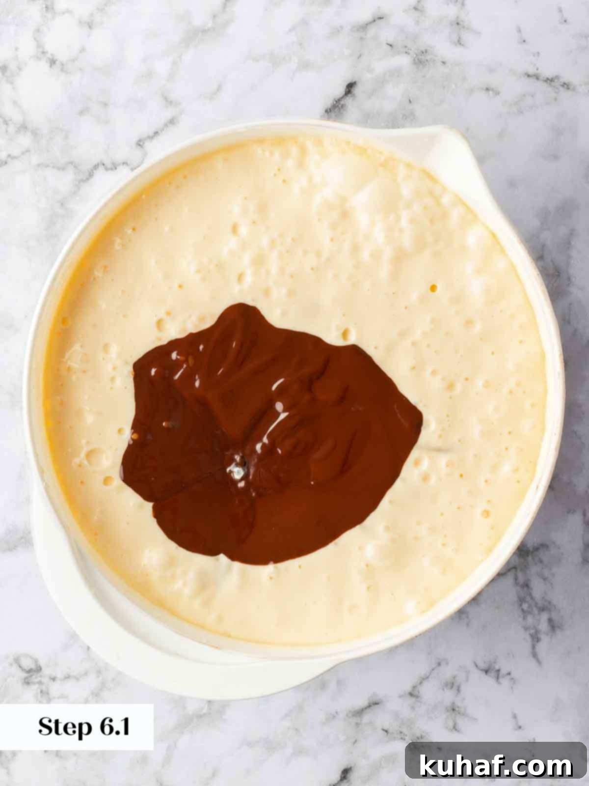 adding melted chocolate to cheesecake batter.